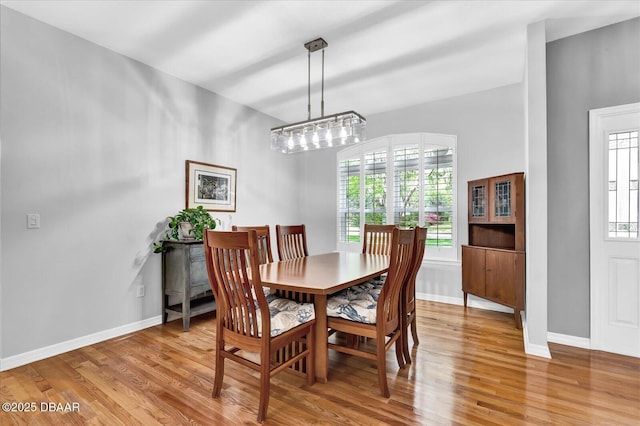 2 Bulows Lndg, Flagler Beach, FL 32136 - dining room featuring light wood-style floors, baseboards, and a chandelier