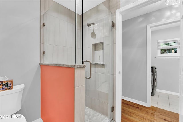 2 Bulows Lndg, Flagler Beach, FL 32136 - bathroom with a stall shower, toilet, wood finished floors, and baseboards