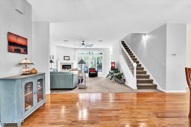 2 Bulows Lndg, Flagler Beach, FL 32136 - living area with a ceiling fan, stairway, light wood-style flooring, a fireplace, and baseboards