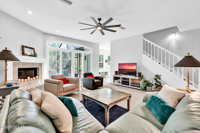 2 Bulows Lndg, Flagler Beach, FL 32136 - carpeted living room featuring stairs, a ceiling fan, a brick fireplace, and recessed lighting
