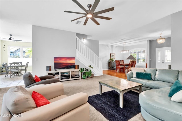 2 Bulows Lndg, Flagler Beach, FL 32136 - living area with a ceiling fan, stairway, and light colored carpet