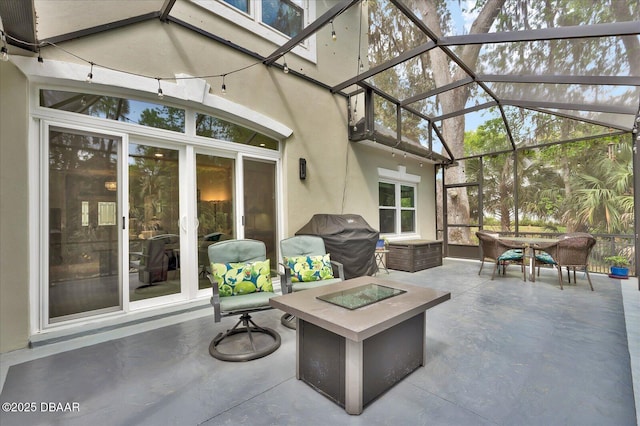 2 Bulows Lndg, Flagler Beach, FL 32136 - view of patio featuring an outdoor fire pit, outdoor dining space, glass enclosure, and a grill