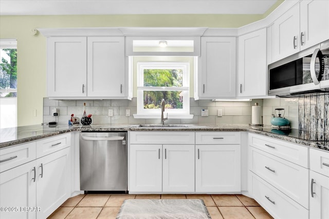 2 Bulows Lndg, Flagler Beach, FL 32136 - kitchen featuring appliances with stainless steel finishes, a sink, tasteful backsplash, and light tile patterned floors