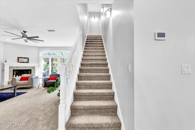 2 Bulows Lndg, Flagler Beach, FL 32136 - stairs featuring carpet floors, a ceiling fan, baseboards, and a fireplace