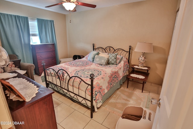 tiled bedroom featuring ceiling fan