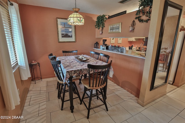 tiled dining room with a textured ceiling