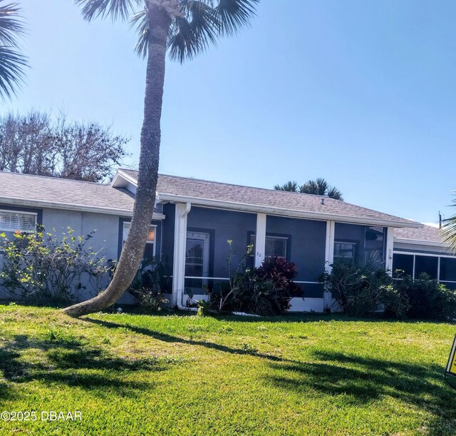 view of side of home with a yard