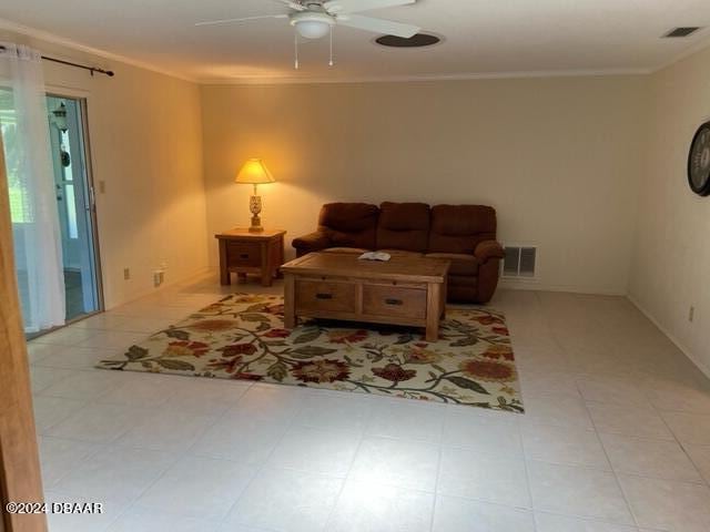 living room featuring ceiling fan and ornamental molding