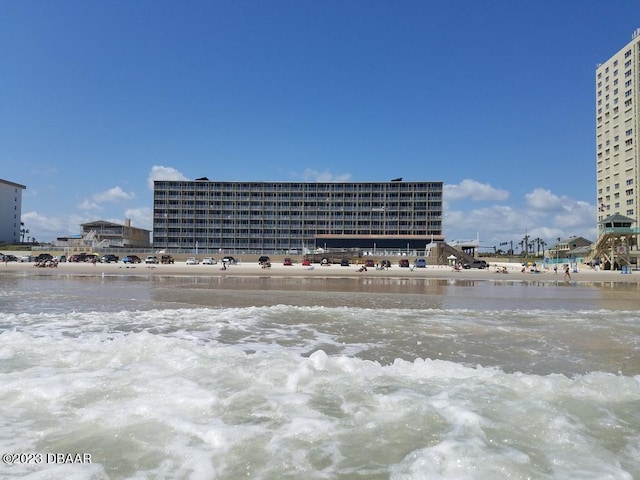 view of property featuring a water view and a view of the beach