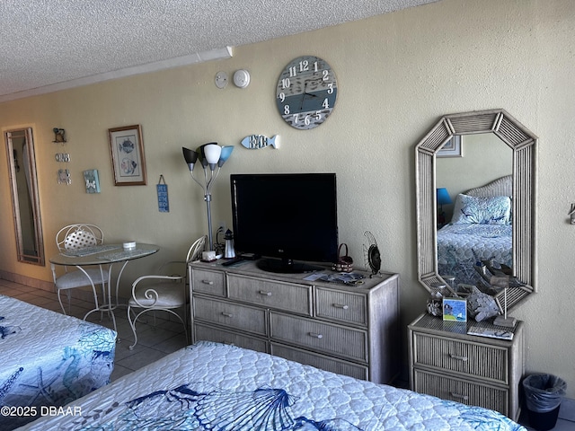 tiled bedroom featuring a textured ceiling