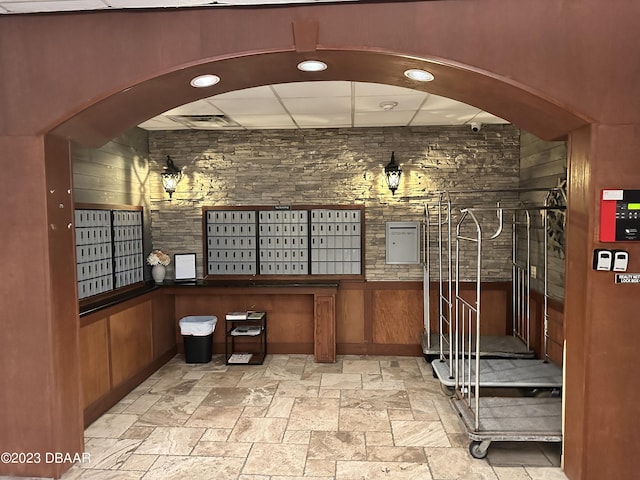 interior space with a mail area and wood walls