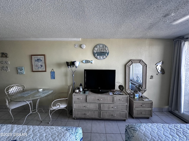 bedroom with a textured ceiling and light tile patterned flooring