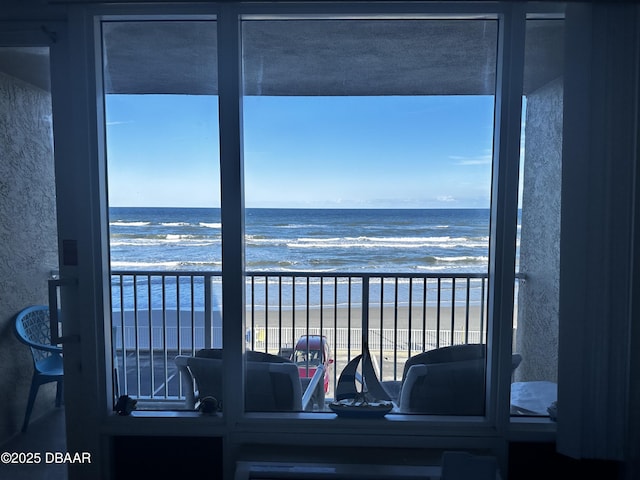 balcony with a beach view and a water view