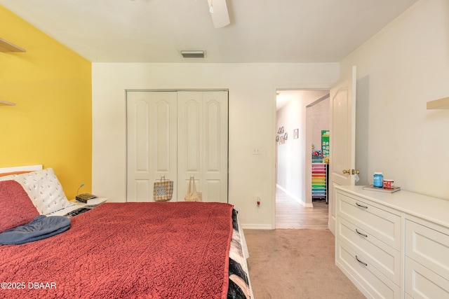 carpeted bedroom featuring a closet and ceiling fan