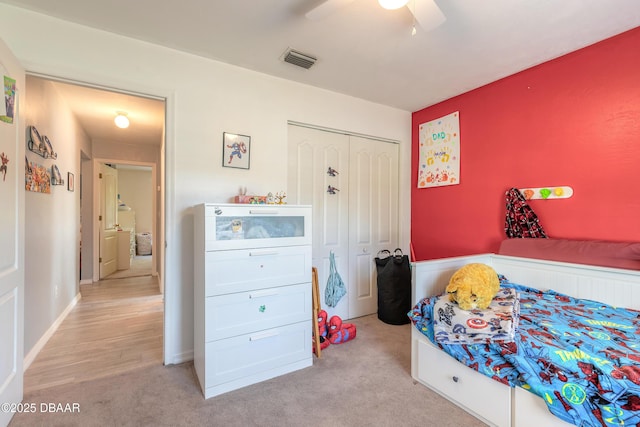 bedroom with light carpet, a closet, and ceiling fan