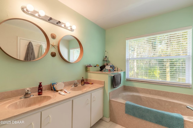 bathroom featuring vanity, tiled tub, and tile patterned flooring