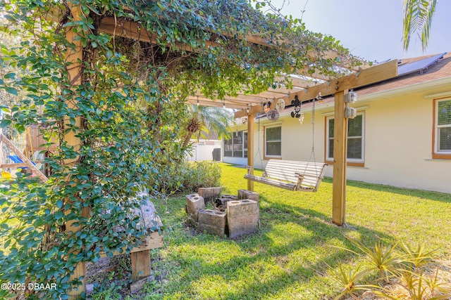 view of yard featuring a pergola and a fire pit