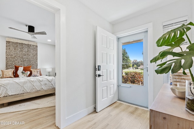 entrance foyer with ceiling fan and light wood-type flooring