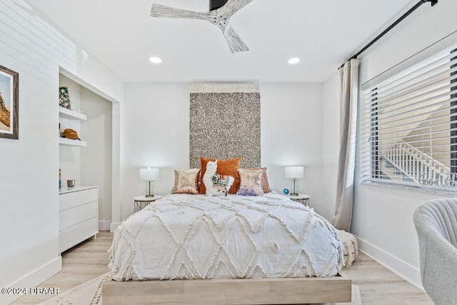 bedroom featuring light wood-type flooring and ceiling fan