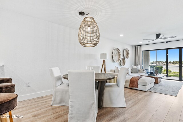 dining room with light wood-type flooring and ceiling fan