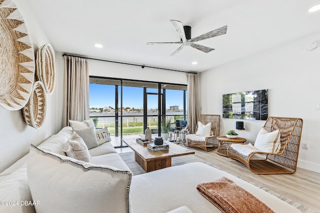 living room with wood-type flooring and ceiling fan