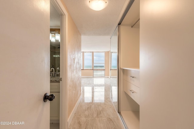 corridor featuring a textured ceiling