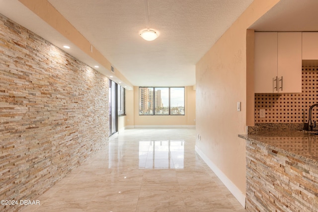 corridor with a textured ceiling