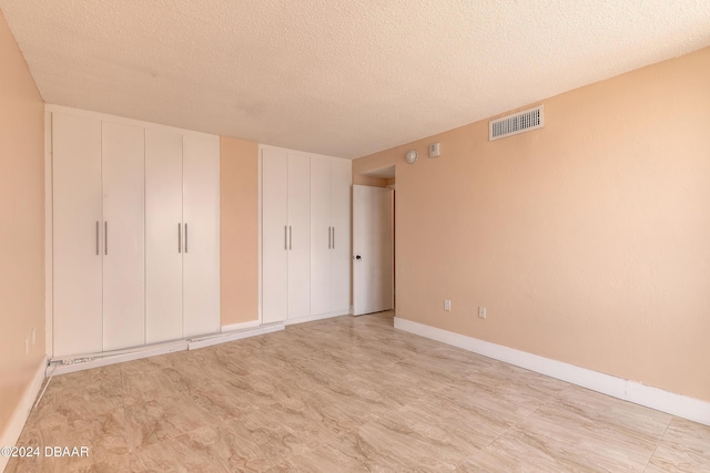 unfurnished bedroom with a textured ceiling