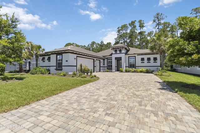 336 Stirling Bridge Dr, Ormond Beach, FL 32174 - prairie-style home with an attached garage, decorative driveway, a front lawn, and stucco siding