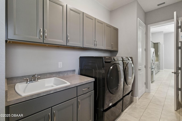 336 Stirling Bridge Dr, Ormond Beach, FL 32174 - laundry room featuring washing machine and clothes dryer, cabinet space, and light tile patterned floors