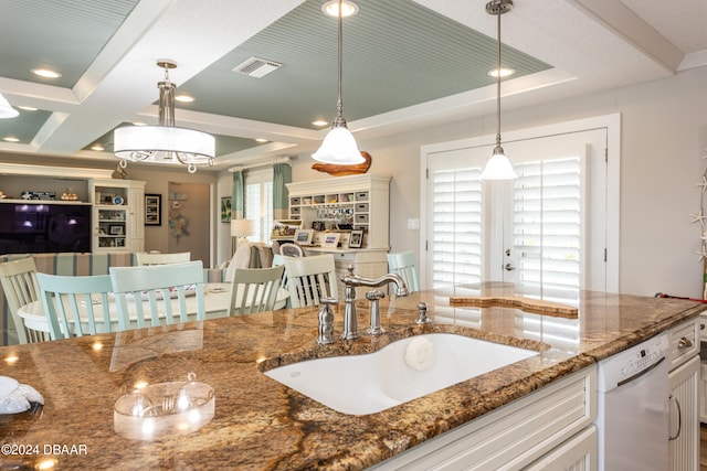 kitchen with dark stone counters, decorative light fixtures, sink, white cabinets, and dishwasher