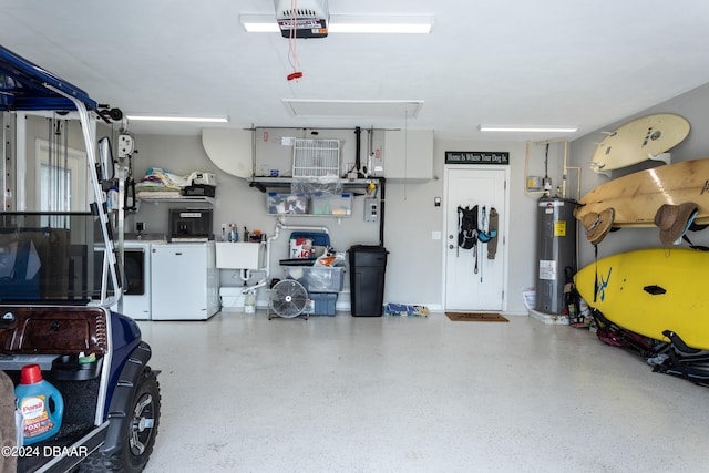 garage featuring electric water heater and washer and dryer