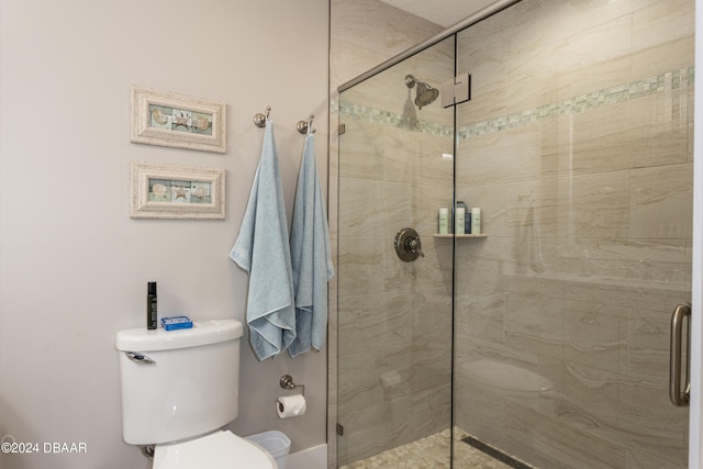 bathroom with an enclosed shower and toilet