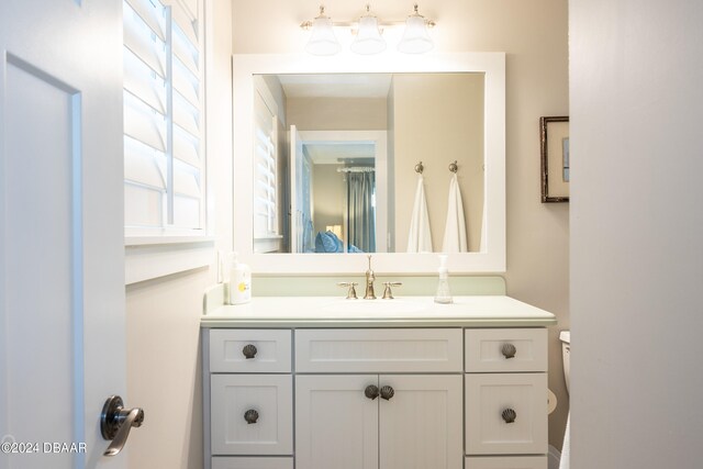 bathroom featuring toilet and vanity