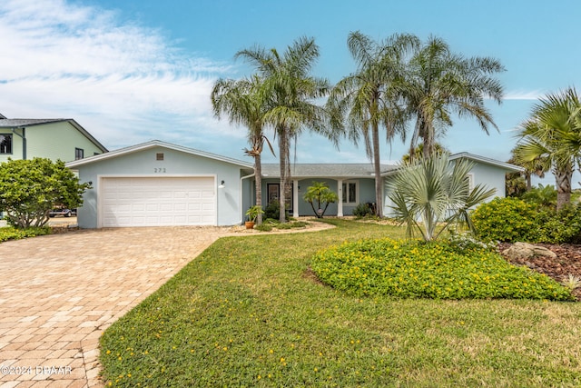 ranch-style house featuring a garage and a front yard