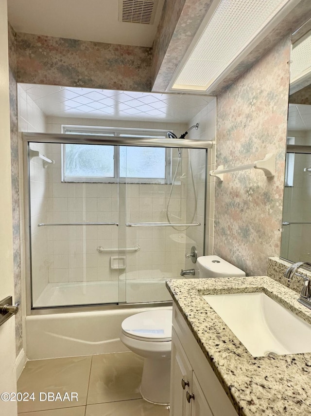 5 Wild Rose Pl, Palm Coast, FL 32164 - full bathroom with tile patterned flooring, vanity, combined bath / shower with glass door, and toilet