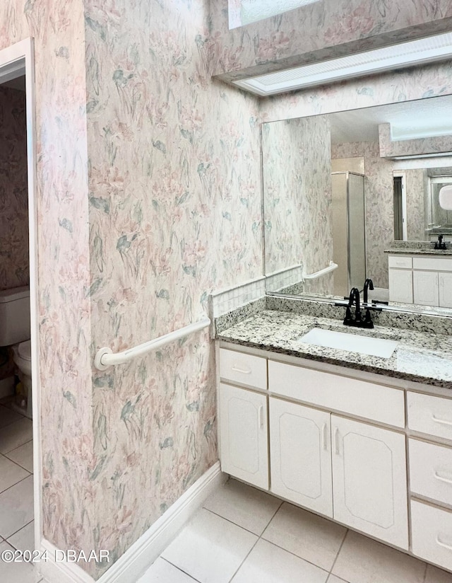 5 Wild Rose Pl, Palm Coast, FL 32164 - bathroom featuring tile patterned flooring, an enclosed shower, vanity, and toilet
