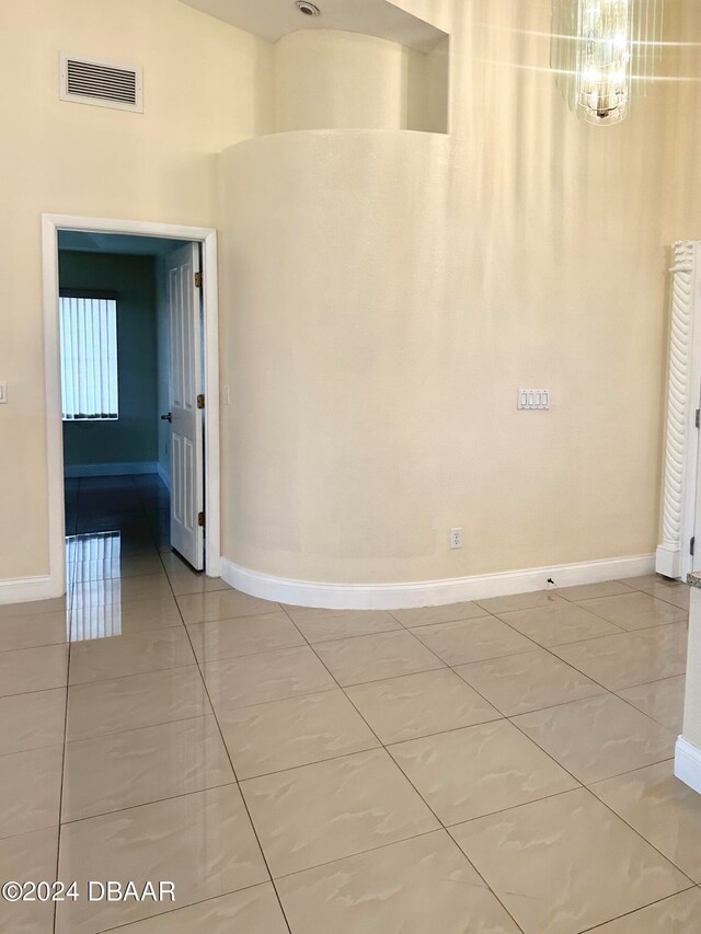 5 Wild Rose Pl, Palm Coast, FL 32164 - spare room featuring a notable chandelier and tile patterned floors