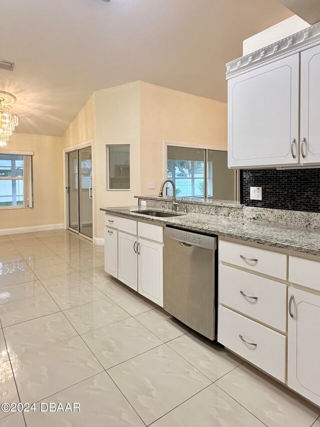 5 Wild Rose Pl, Palm Coast, FL 32164 - kitchen with stainless steel dishwasher, sink, vaulted ceiling, and white cabinets