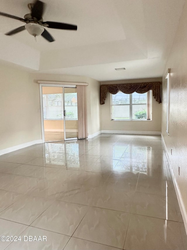 5 Wild Rose Pl, Palm Coast, FL 32164 - empty room featuring ceiling fan, plenty of natural light, and a raised ceiling