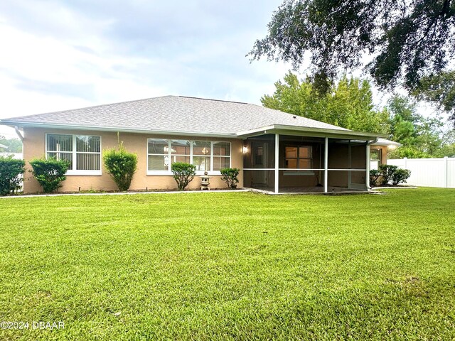5 Wild Rose Pl, Palm Coast, FL 32164 - rear view of house with a sunroom and a yard