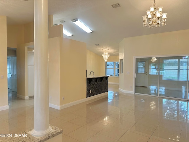 5 Wild Rose Pl, Palm Coast, FL 32164 - empty room featuring ornate columns, a notable chandelier, light tile patterned floors, and sink