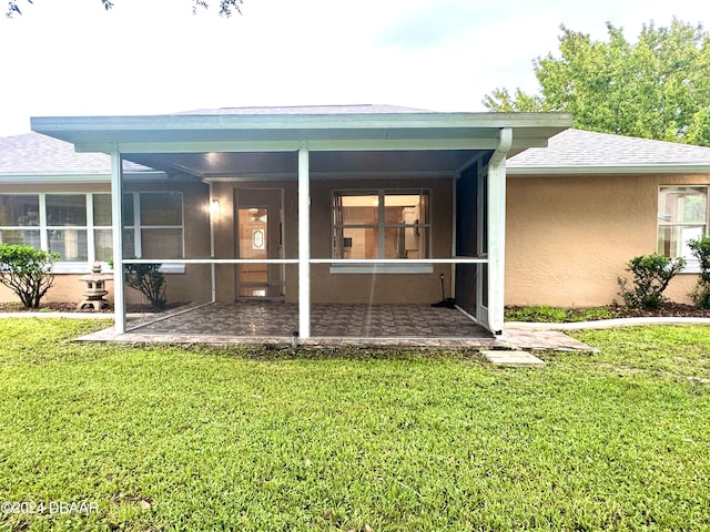 5 Wild Rose Pl, Palm Coast, FL 32164 - rear view of property with a sunroom, a patio, and a yard