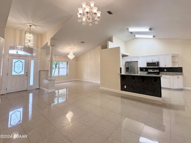 5 Wild Rose Pl, Palm Coast, FL 32164 - entryway with high vaulted ceiling, an inviting chandelier, and light tile patterned floors