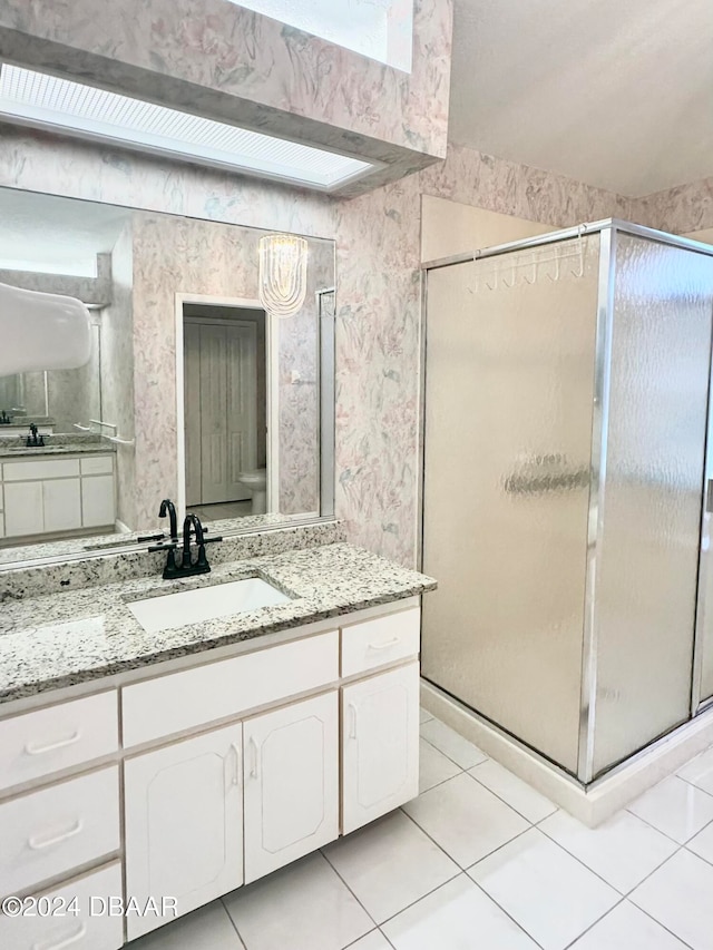 5 Wild Rose Pl, Palm Coast, FL 32164 - bathroom featuring toilet, vanity, tile patterned flooring, and a shower with door