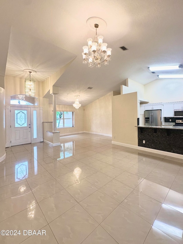 5 Wild Rose Pl, Palm Coast, FL 32164 - entrance foyer with a chandelier and vaulted ceiling