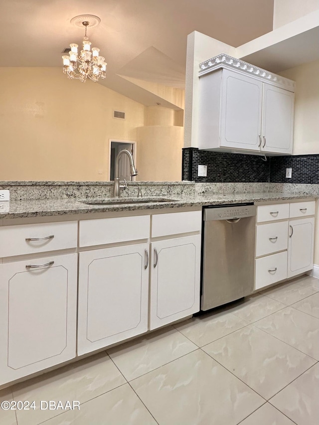 5 Wild Rose Pl, Palm Coast, FL 32164 - kitchen featuring vaulted ceiling, an inviting chandelier, stainless steel dishwasher, backsplash, and white cabinetry