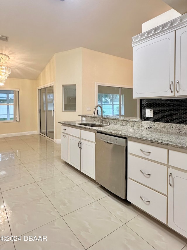 5 Wild Rose Pl, Palm Coast, FL 32164 - kitchen with stainless steel dishwasher, white cabinetry, sink, and vaulted ceiling