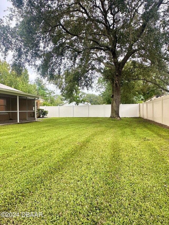 5 Wild Rose Pl, Palm Coast, FL 32164 - view of yard with a sunroom