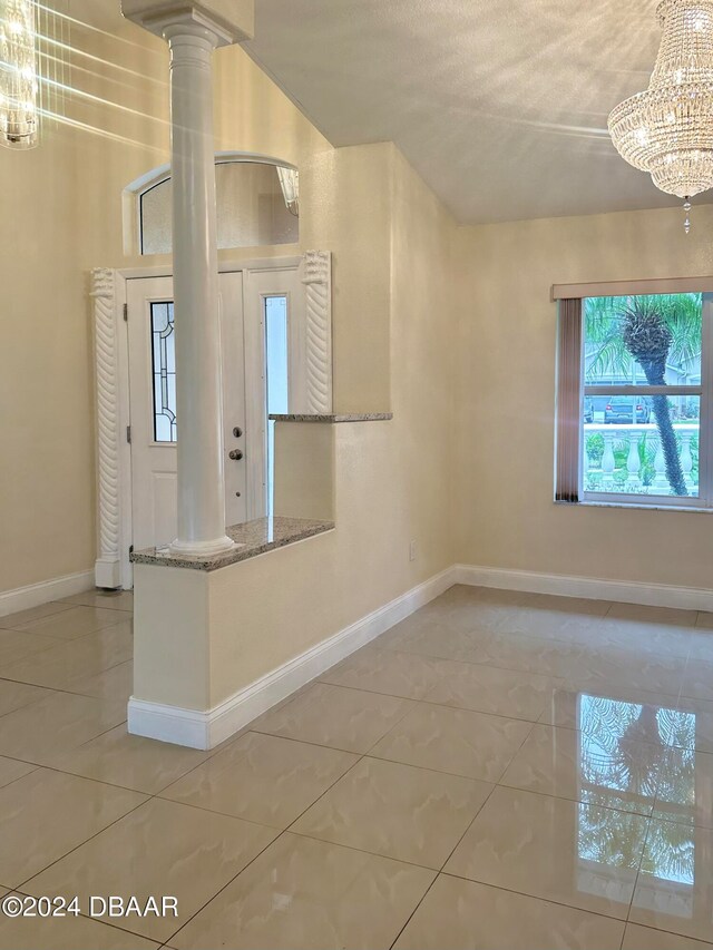 5 Wild Rose Pl, Palm Coast, FL 32164 - entrance foyer featuring a textured ceiling, a chandelier, and tile patterned floors